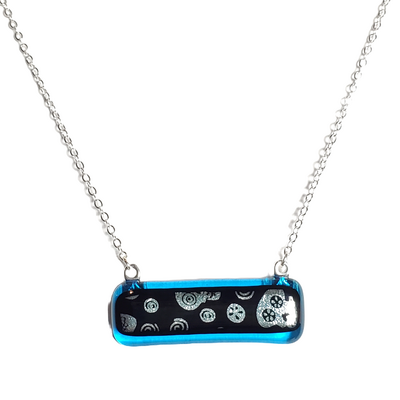 Dichroic silver skulls on transparent blue fused glass bar necklace
